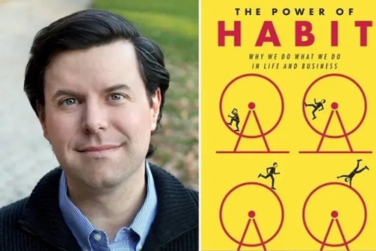A man next to a book titled the power of habit